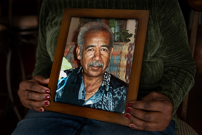 Woman holds a photo of African-American man