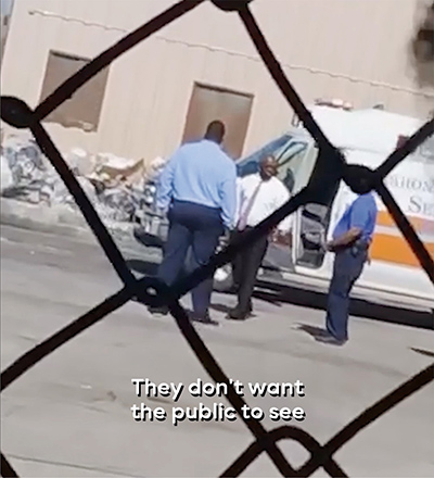 An ambulance with its door ajar, a police officer, and two men in business clothes, pictured from behind an iron link face, with the subtitle 'They don't want the public to see.'